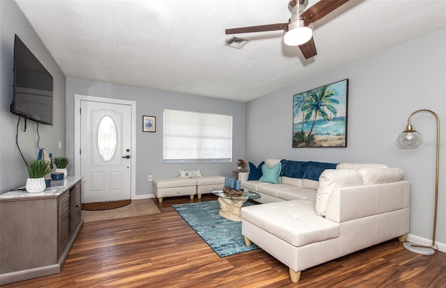 living room featuring ceiling fan and dark hardwood / wood-style flooring