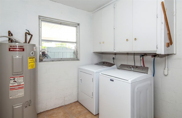 washroom with light tile patterned flooring, cabinets, separate washer and dryer, and electric water heater