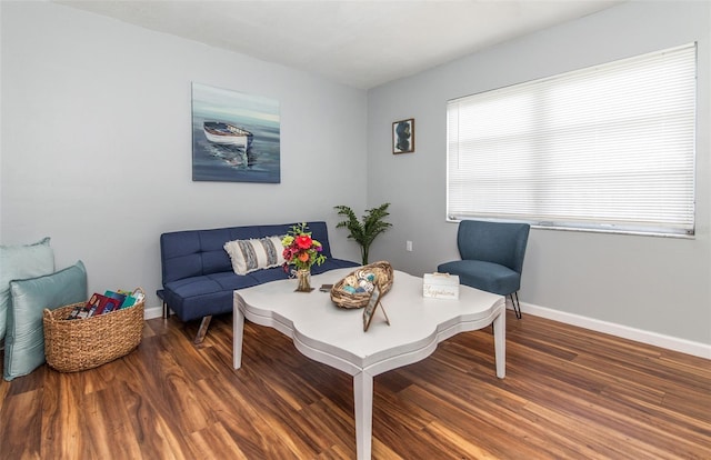 living area with a healthy amount of sunlight and dark wood-type flooring