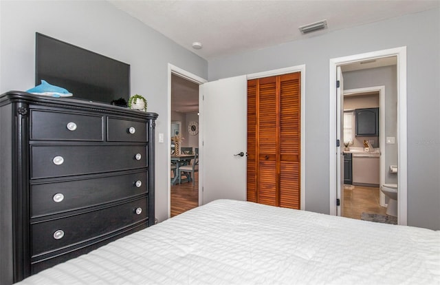 bedroom featuring ensuite bathroom and a closet