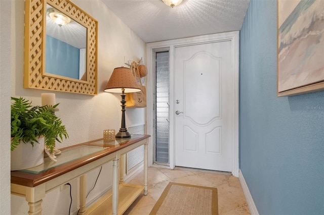 entryway featuring a textured ceiling