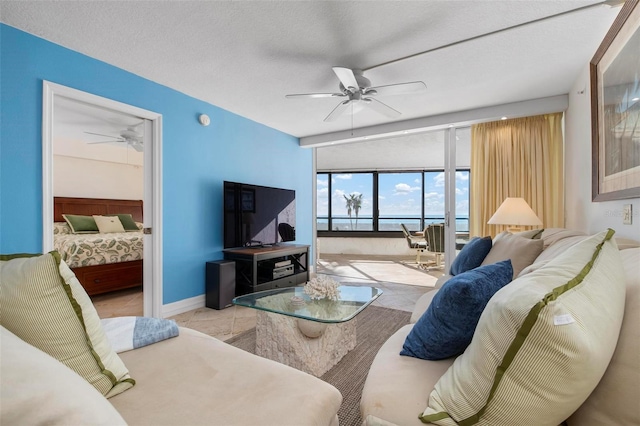 living room featuring a textured ceiling and ceiling fan