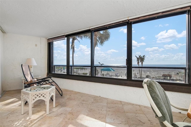 sunroom / solarium featuring a water view