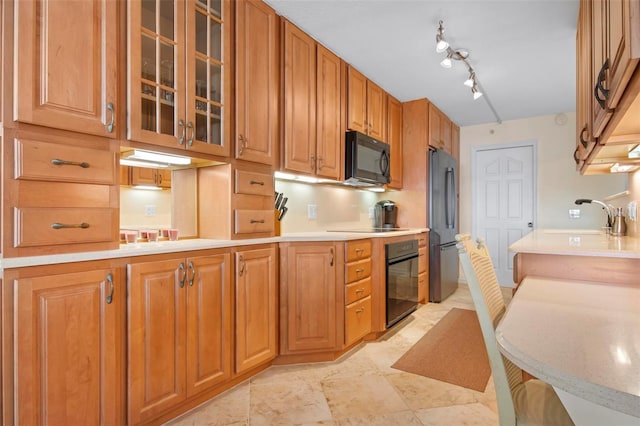 kitchen with sink and black appliances