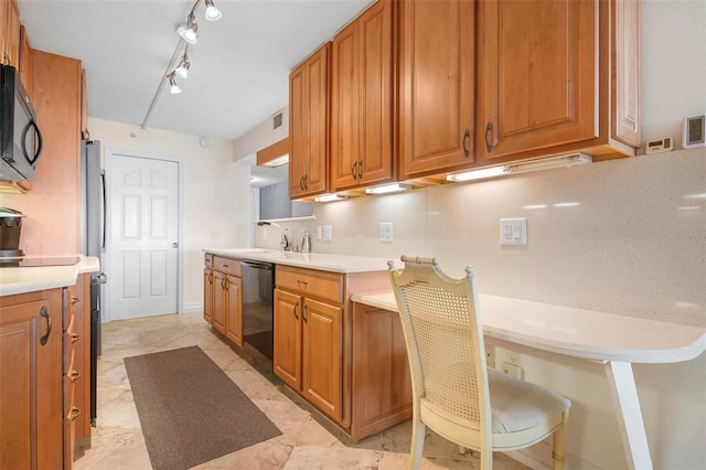 kitchen featuring rail lighting, sink, and black appliances