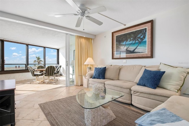 living room featuring ceiling fan and floor to ceiling windows