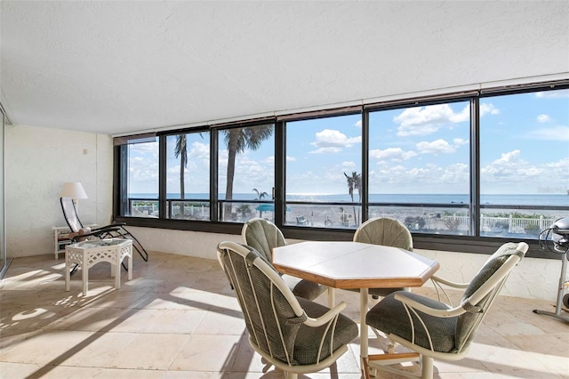 sunroom / solarium featuring a water view