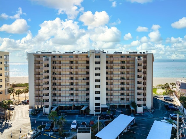 view of property featuring a view of the beach and a water view