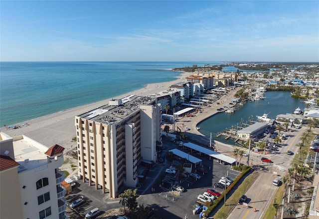 birds eye view of property featuring a water view and a view of the beach