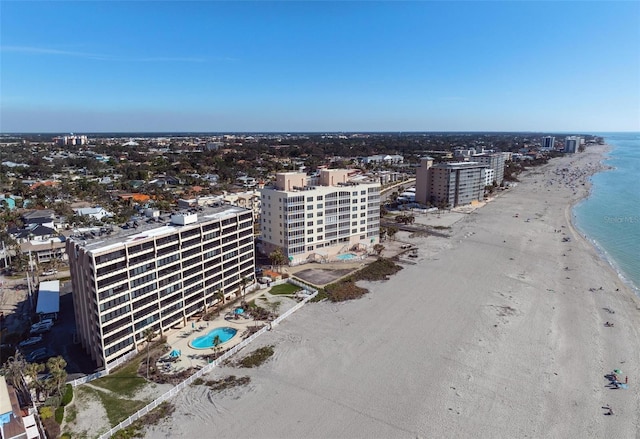 bird's eye view featuring a water view and a beach view