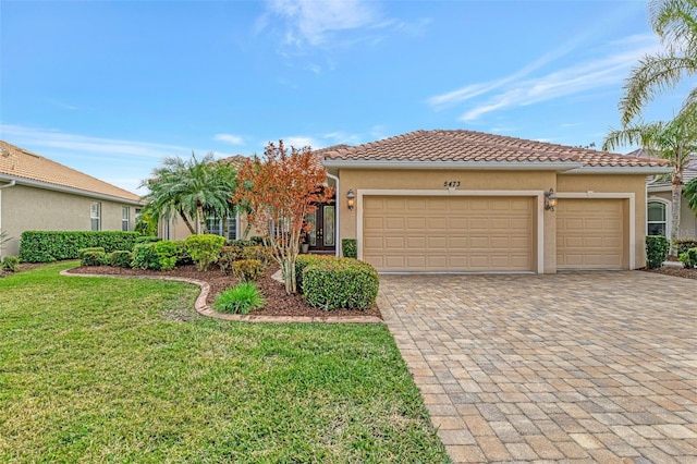 view of front of home with a garage and a front yard