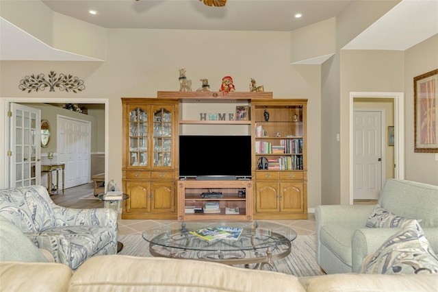 tiled living room with ceiling fan