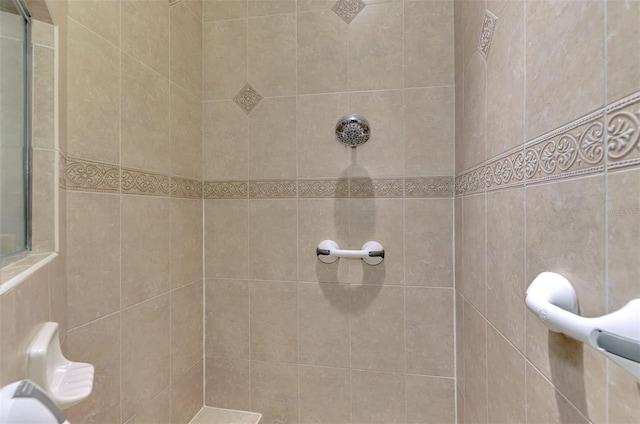 bathroom with tiled shower