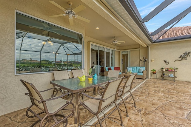 view of patio / terrace with ceiling fan and a lanai