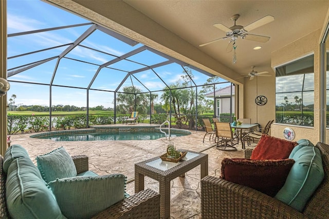 view of swimming pool with a lanai, ceiling fan, a patio area, and outdoor lounge area