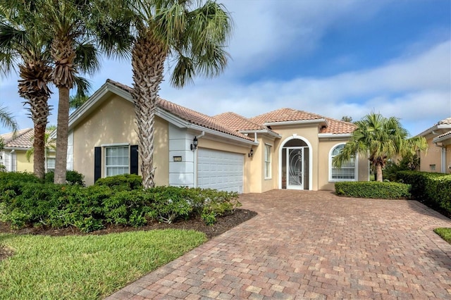 mediterranean / spanish-style home featuring a garage