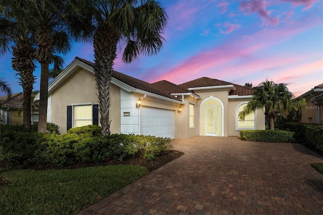 mediterranean / spanish-style home featuring a garage