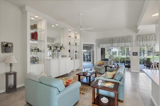 tiled living room featuring built in features and ceiling fan