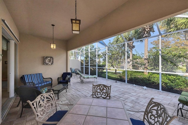 view of patio featuring an outdoor living space and glass enclosure