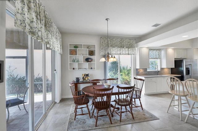 dining space with a chandelier and plenty of natural light