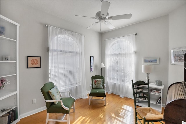 living area featuring ceiling fan and light wood-type flooring