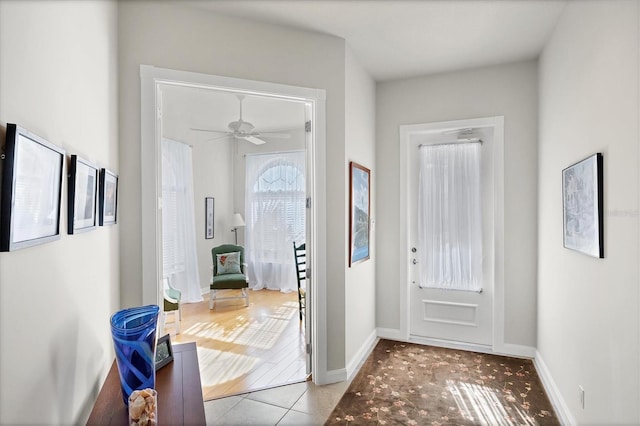 entryway with ceiling fan and light tile patterned floors