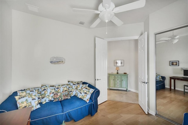 bedroom with hardwood / wood-style floors, a closet, and ceiling fan