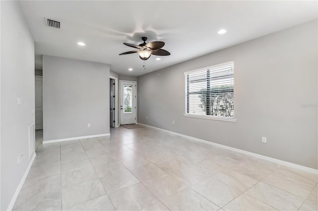 empty room featuring a wealth of natural light and ceiling fan