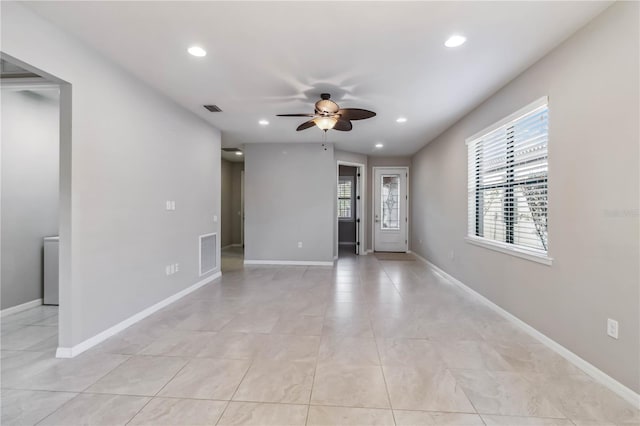 unfurnished room featuring light tile patterned flooring and ceiling fan