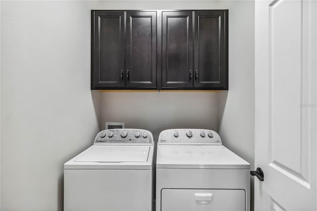 washroom featuring cabinets and independent washer and dryer