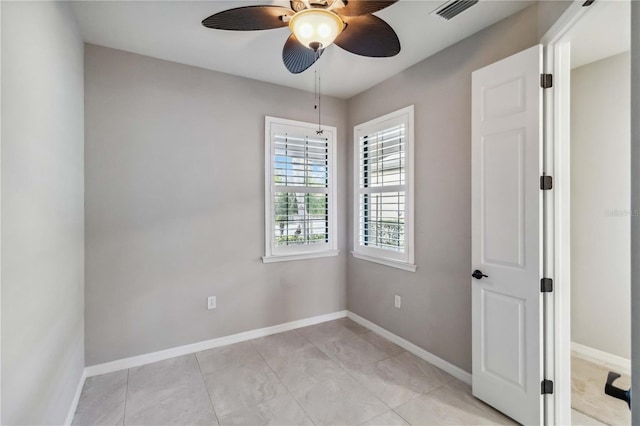 tiled empty room with ceiling fan