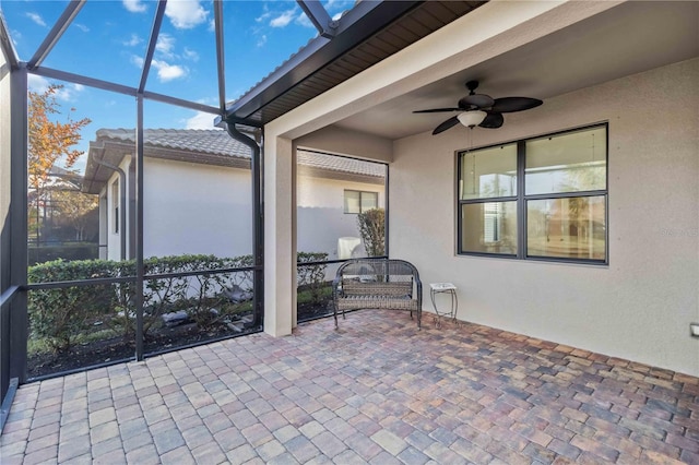 unfurnished sunroom with ceiling fan