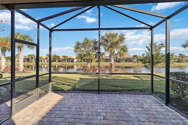 unfurnished sunroom with a water view