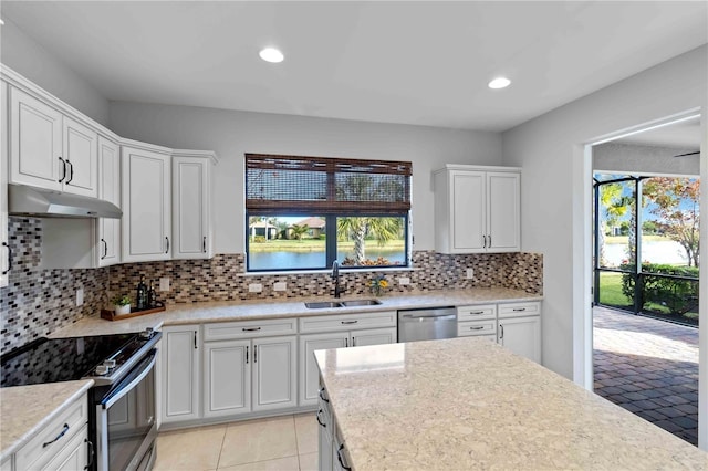 kitchen featuring white cabinetry, sink, backsplash, and stainless steel appliances