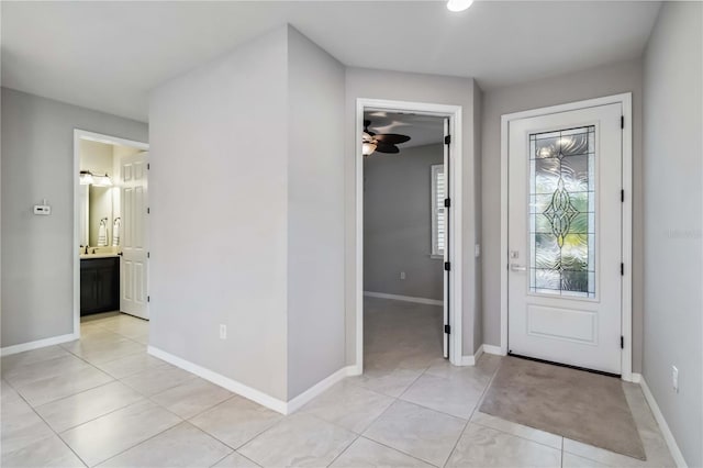 tiled foyer with ceiling fan