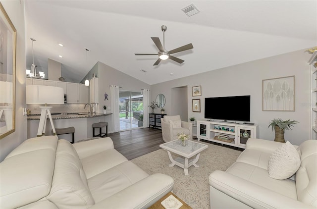 living room with lofted ceiling, sink, dark wood-type flooring, and ceiling fan