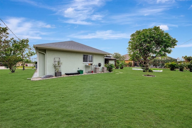 rear view of house featuring a lawn