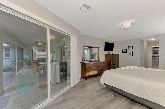 bedroom with wood-type flooring and a textured ceiling