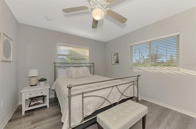 bedroom with wood-type flooring and ceiling fan