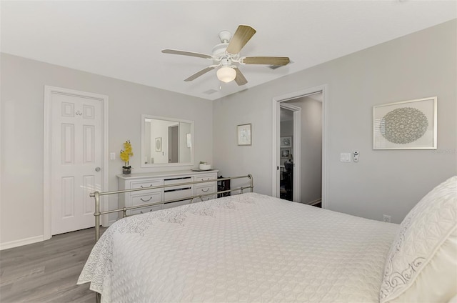 bedroom with light hardwood / wood-style flooring and ceiling fan