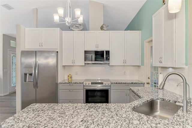 kitchen featuring sink, light stone countertops, white cabinets, and appliances with stainless steel finishes