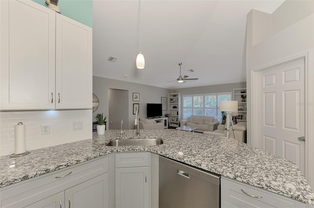 kitchen featuring sink, white cabinetry, light stone counters, tasteful backsplash, and dishwasher