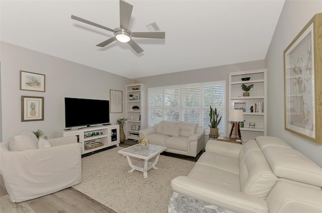 living room featuring light hardwood / wood-style floors and ceiling fan