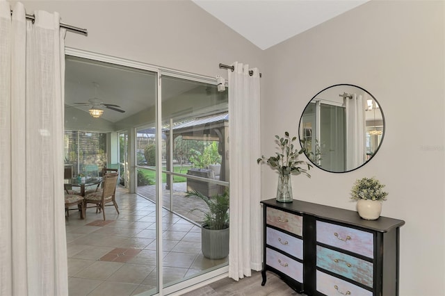 doorway to outside featuring lofted ceiling and ceiling fan