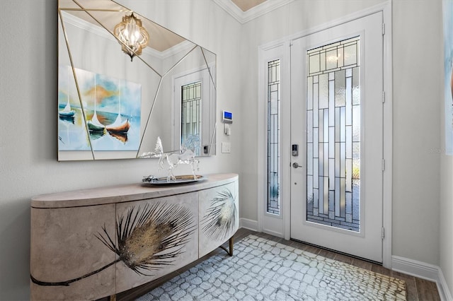 entryway with ornamental molding and light hardwood / wood-style floors