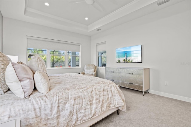 bedroom featuring a raised ceiling, ornamental molding, and light carpet