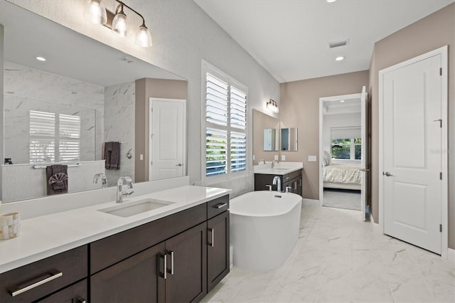 bathroom with vanity and a tub