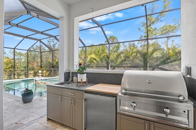 view of patio with an outdoor kitchen, a lanai, sink, and area for grilling