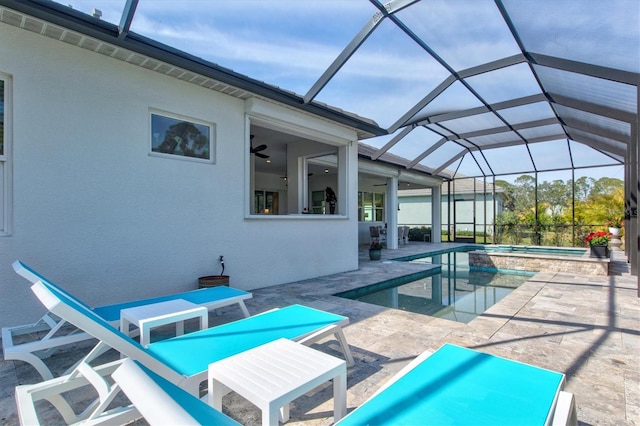 view of swimming pool featuring a lanai, a patio area, and ceiling fan