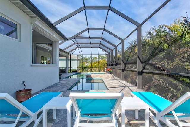 view of pool featuring an in ground hot tub, a lanai, and a patio area